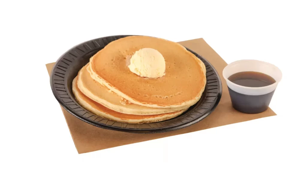 Three griddle cakes with syrup